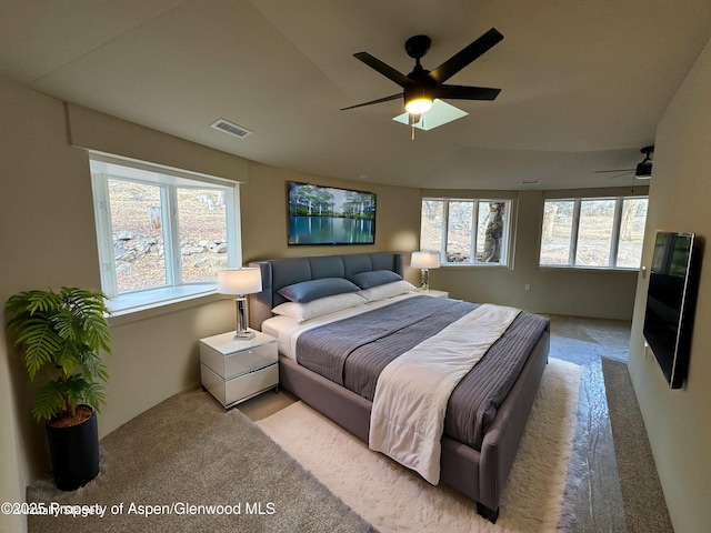 bedroom with ceiling fan and light carpet