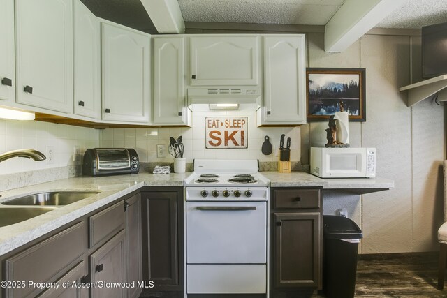 11101 County Road 117 Unit E-5, Glenwood Springs, CO 81601 - kitchen with white appliances, under cabinet range hood, a sink, decorative backsplash, and beamed ceiling