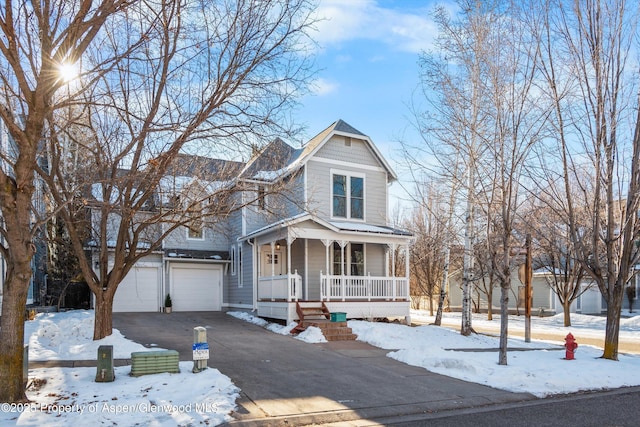 view of front facade with a porch and a garage