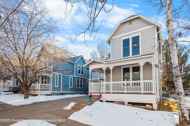 view of property with central air condition unit and covered porch