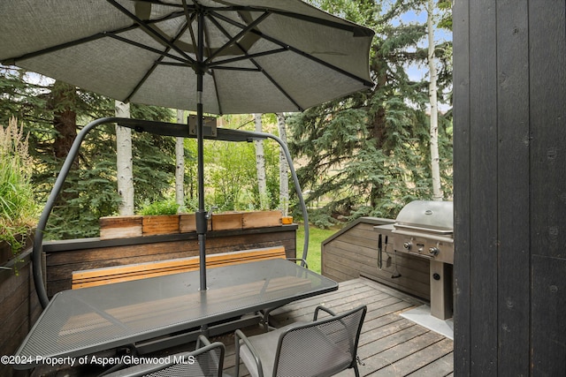 wooden terrace with outdoor dining space