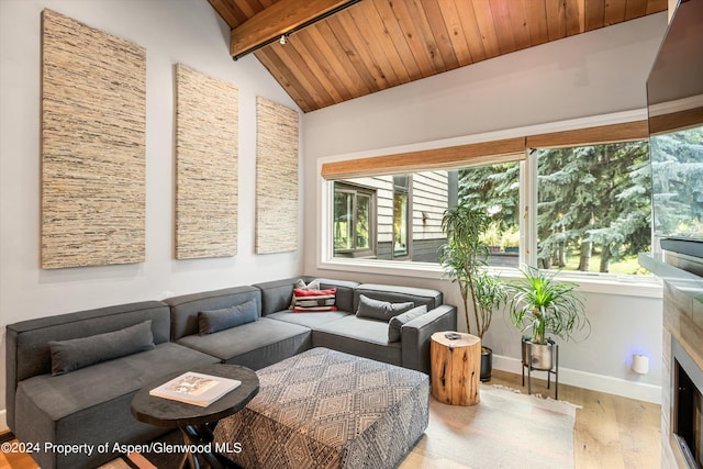 sunroom featuring vaulted ceiling with beams, a fireplace, and wood ceiling