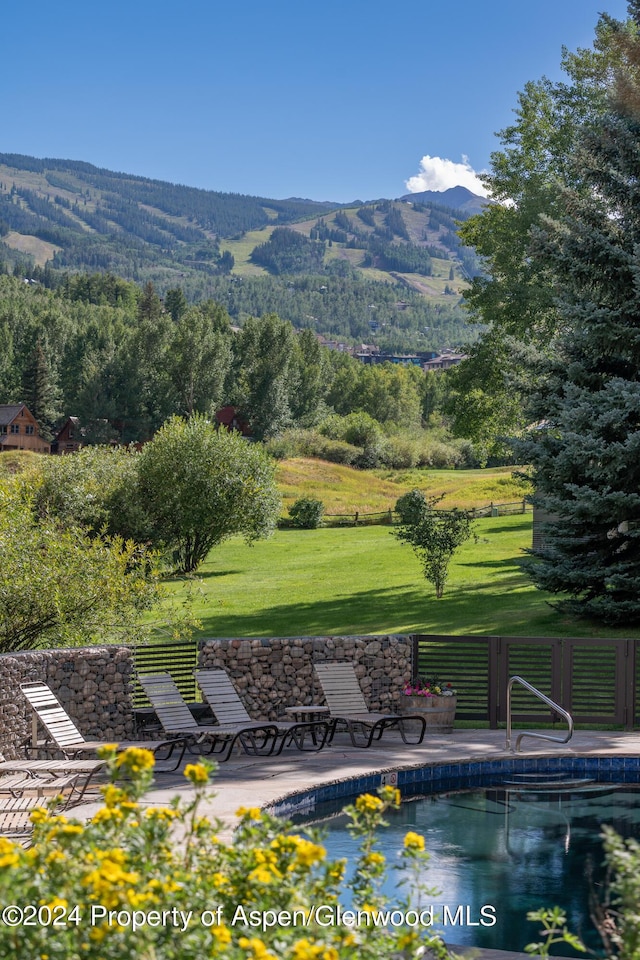 exterior space with a lawn and a mountain view