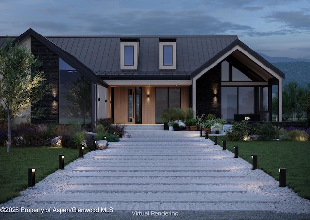 view of front of home featuring a mountain view and a yard