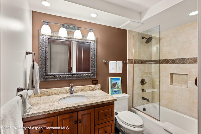 bathroom featuring vanity, recessed lighting, shower / bathtub combination, and toilet