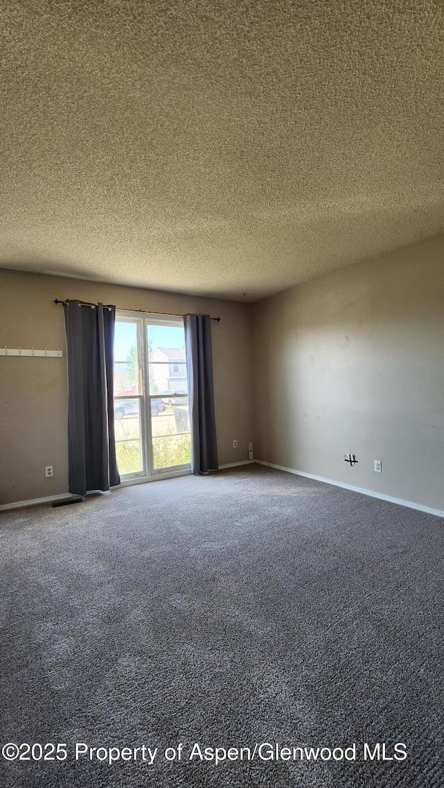 3863 W 6th St, Craig, CO 81625 - empty room with carpet floors, a textured ceiling, and baseboards