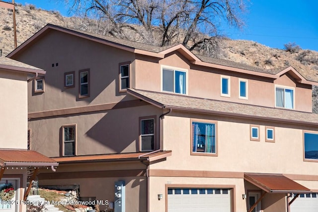 view of front facade with a mountain view and a garage