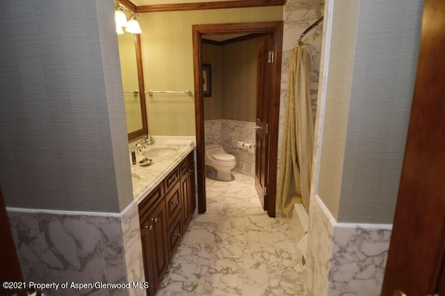 bathroom featuring crown molding, vanity, and toilet