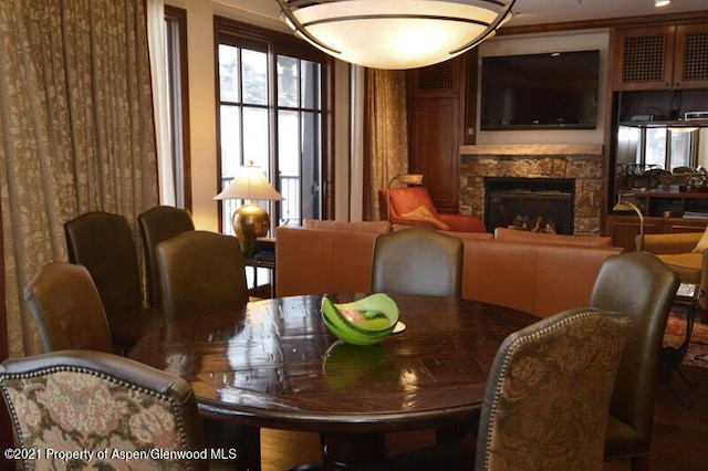 dining space with a stone fireplace