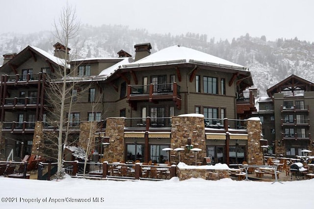 snow covered building with a mountain view