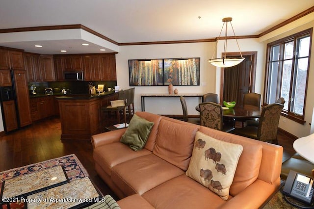 living room with dark hardwood / wood-style flooring and ornamental molding