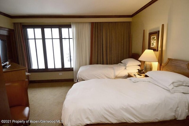 bedroom with light carpet and crown molding