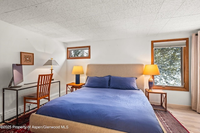 1501 Maroon Creek Rd # 2, Aspen, CO 81611 - bedroom with wood finished floors and multiple windows