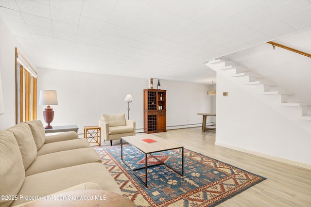 1501 Maroon Creek Rd # 2, Aspen, CO 81611 - living room with wood finished floors, a baseboard heating unit, and stairway