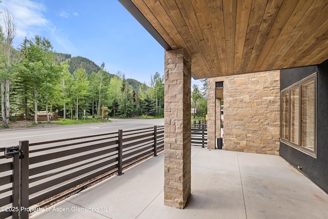 1501 Maroon Creek Rd # 2, Aspen, CO 81611 - view of patio / terrace with a mountain view and a wooded view