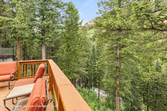 1501 Maroon Creek Rd # 2, Aspen, CO 81611 - wooden deck featuring a wooded view