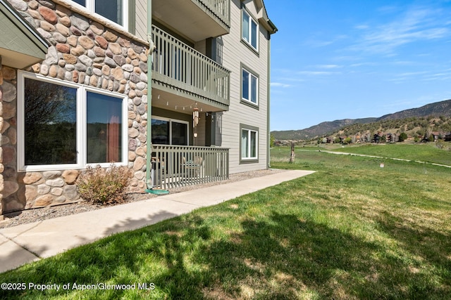 exterior space with a balcony and a mountain view