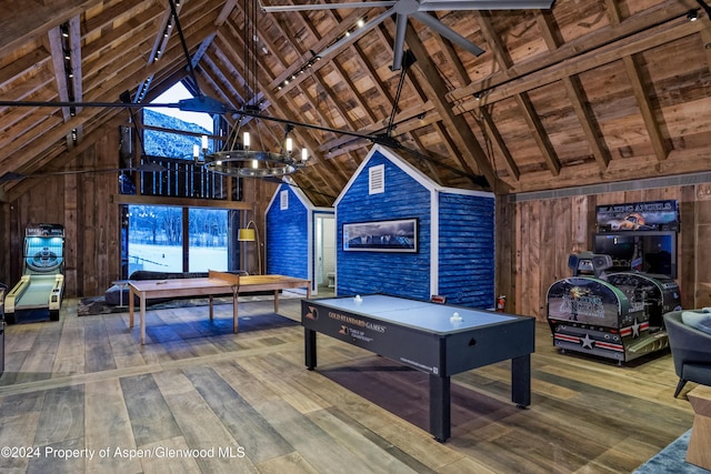 playroom with wooden ceiling, high vaulted ceiling, wood walls, a chandelier, and hardwood / wood-style flooring