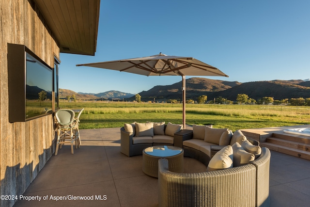 view of patio / terrace with a mountain view, a rural view, and an outdoor hangout area