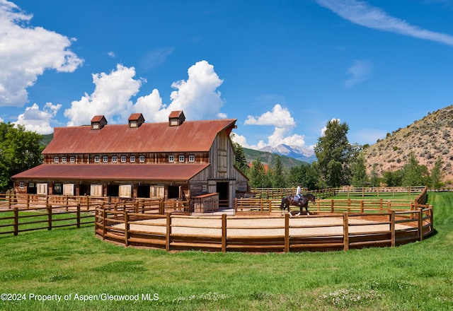 rear view of property with a mountain view and a rural view