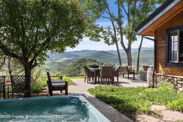 47 Mule Deer Run, Snowmass, CO 81654 - view of pool featuring a mountain view, a patio, and outdoor dining space
