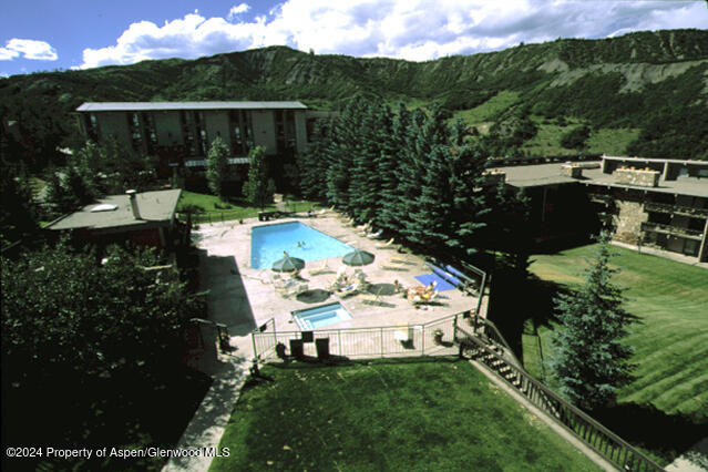 300 Carriage Way Unit 614, Snowmass Village, CO 81615 - community pool featuring a mountain view and a patio area