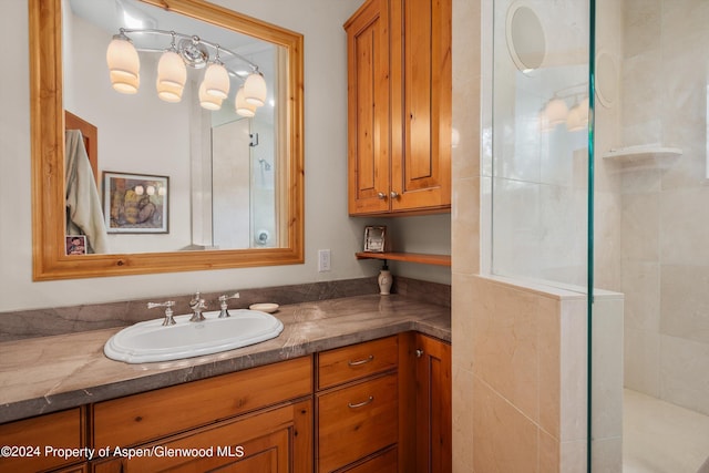 bathroom with vanity and tiled shower
