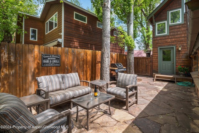view of patio / terrace with fence, an outdoor hangout area, and grilling area