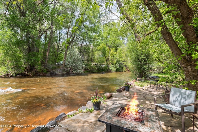 view of yard with a fire pit and a patio