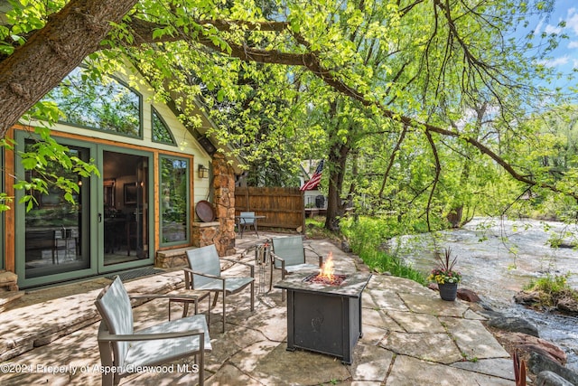 view of patio / terrace with a fire pit and fence