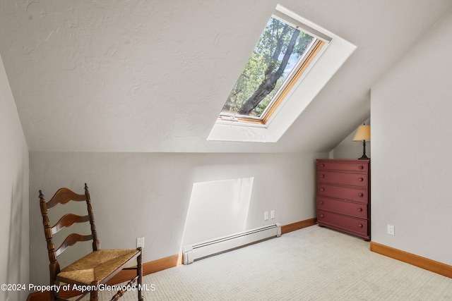 additional living space with a baseboard heating unit, a skylight, lofted ceiling, baseboards, and carpet floors
