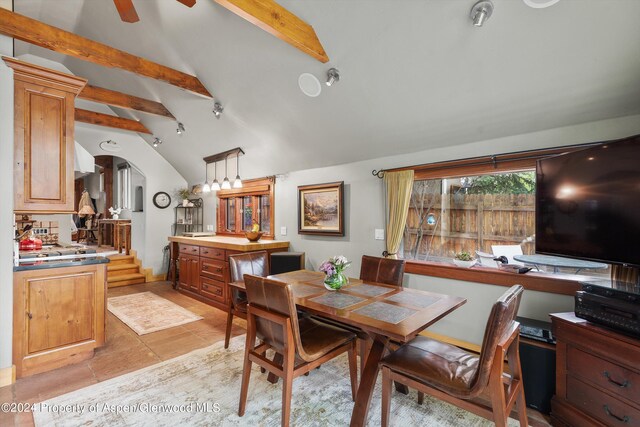 dining area featuring ceiling fan and arched walkways