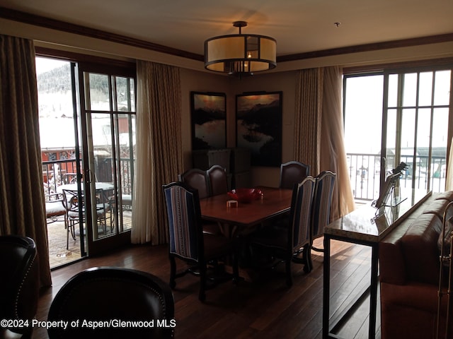 dining space with ornamental molding and dark hardwood / wood-style flooring