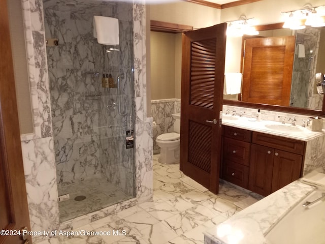 bathroom with vanity, toilet, tile walls, and a tile shower