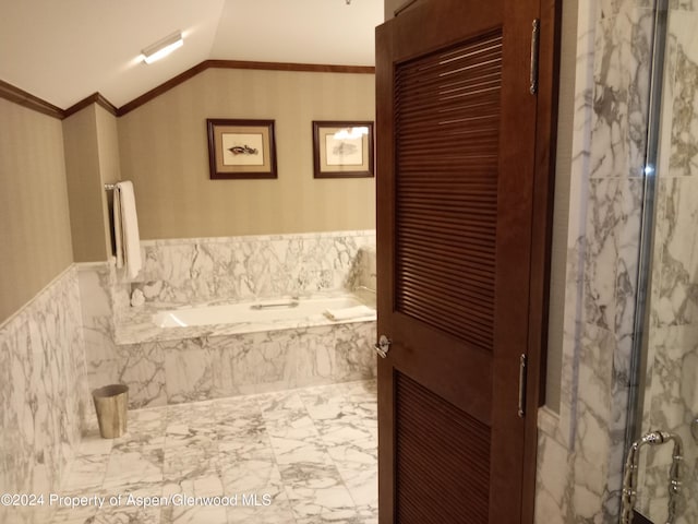 bathroom with lofted ceiling, ornamental molding, and shower with separate bathtub