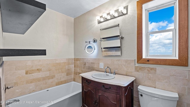 full bathroom featuring toilet, tile walls, a bath, and vanity