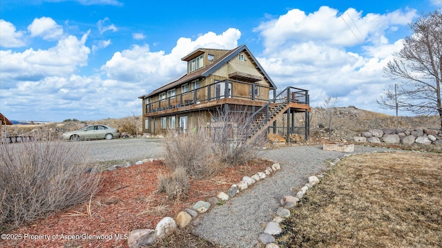 back of house with stairs and a deck