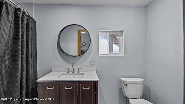bathroom featuring vanity and toilet
