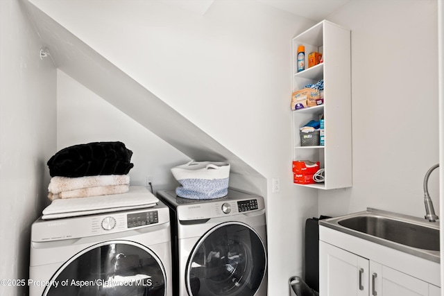 washroom featuring separate washer and dryer, a sink, and cabinet space