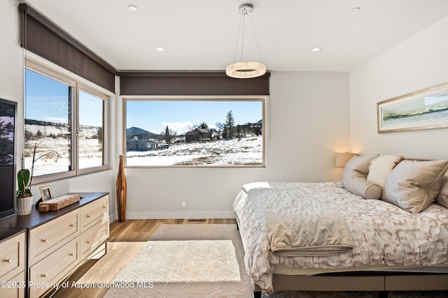 bedroom with light wood-style floors, recessed lighting, and baseboards