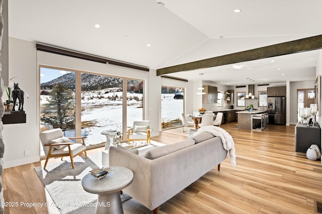 living room featuring light wood-style flooring, recessed lighting, visible vents, baseboards, and vaulted ceiling