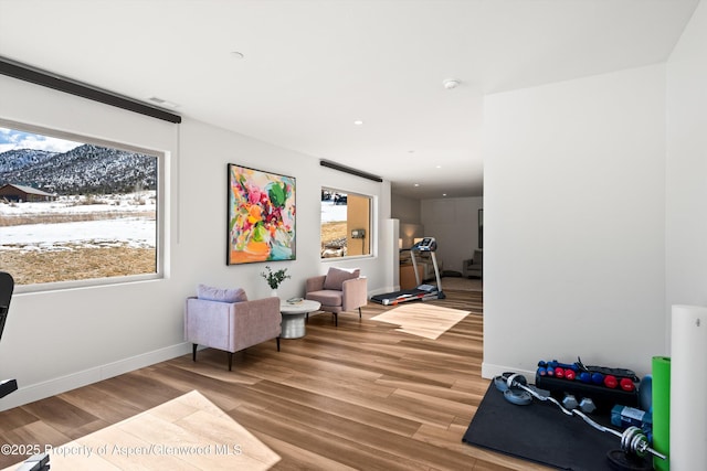 sitting room featuring light wood-type flooring, baseboards, stairway, and recessed lighting