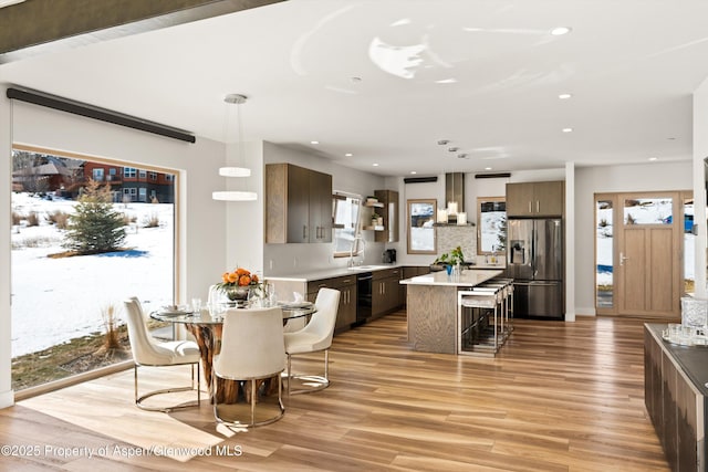 dining room with light wood-style flooring and recessed lighting