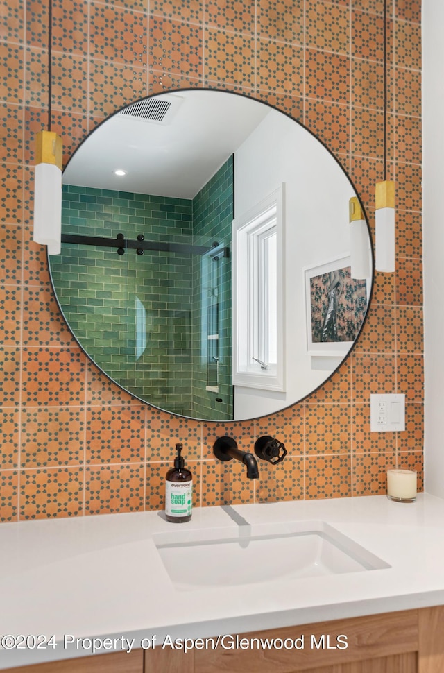 bathroom with decorative backsplash and vanity