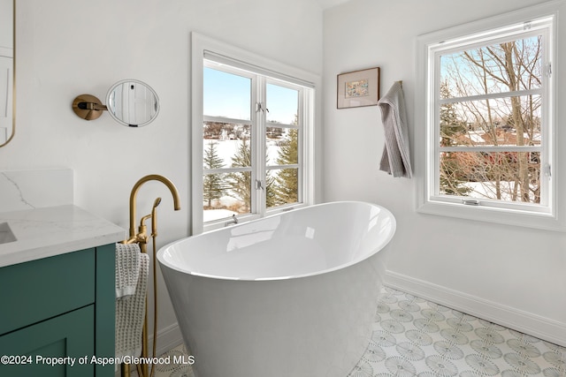 bathroom with vanity and a bath