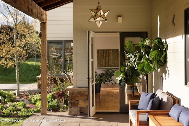 doorway to property with outdoor lounge area and a patio