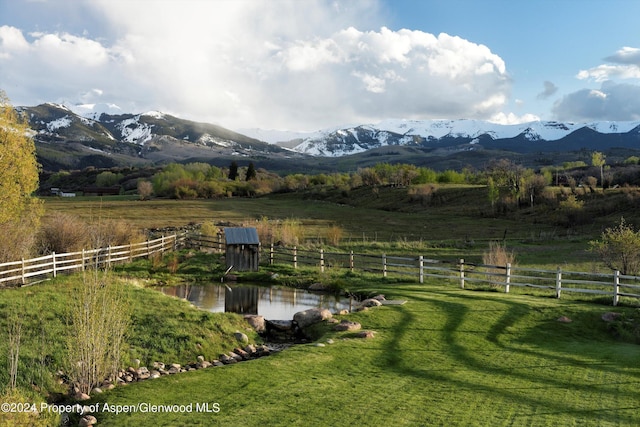 view of mountain feature featuring a water view and a rural view