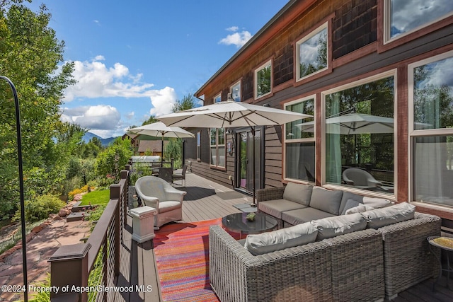 view of patio with an outdoor living space and a deck