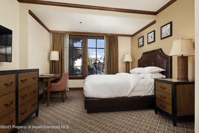 carpeted bedroom with ornamental molding