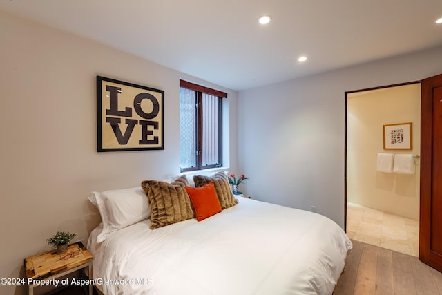 bedroom with recessed lighting and wood finished floors